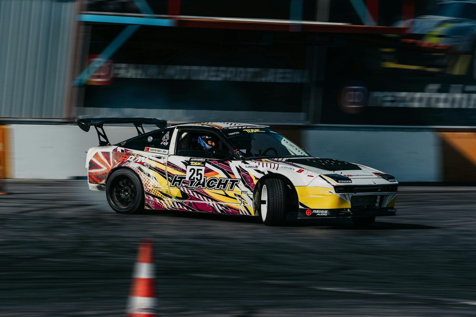 Dynamic shot of a racing car drifting on a track during daylight in Istanbul, Turkey. on About page of cars and cars
